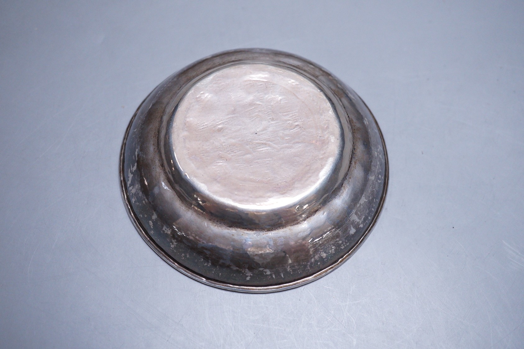 Three Persian engraved white metal finger bowls, (a.f.) diameter 10.6cm, 235 grams.